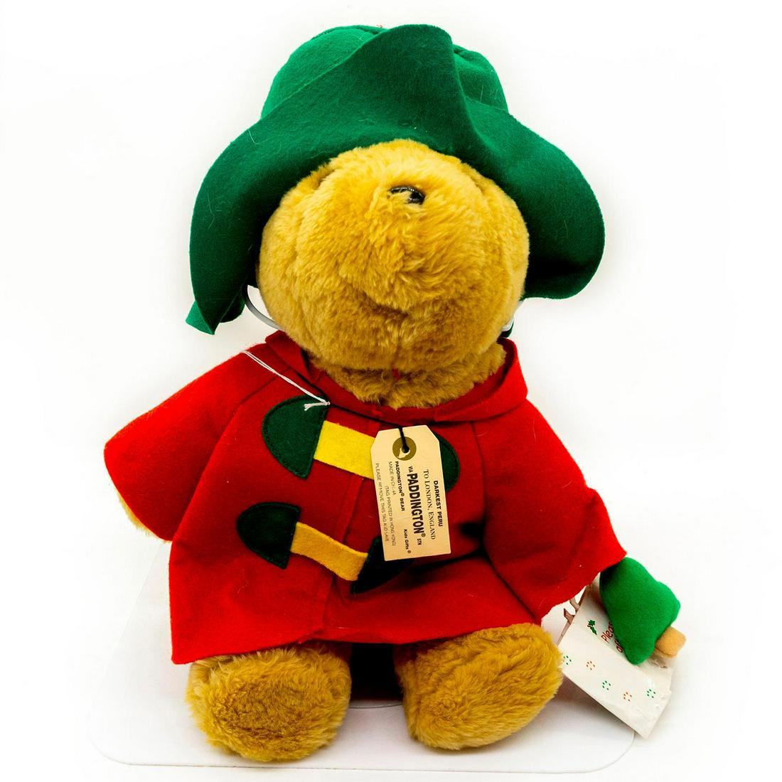 Paddington Bears Teddy Bear, Christmas: Plush, glass eyes, wearing holiday outfit. Wearing a red jacket with yellow and green buckles that also match his hat. Holding a Christmas gift bag and a Paddington tree ornament. #paddingtonbears #te