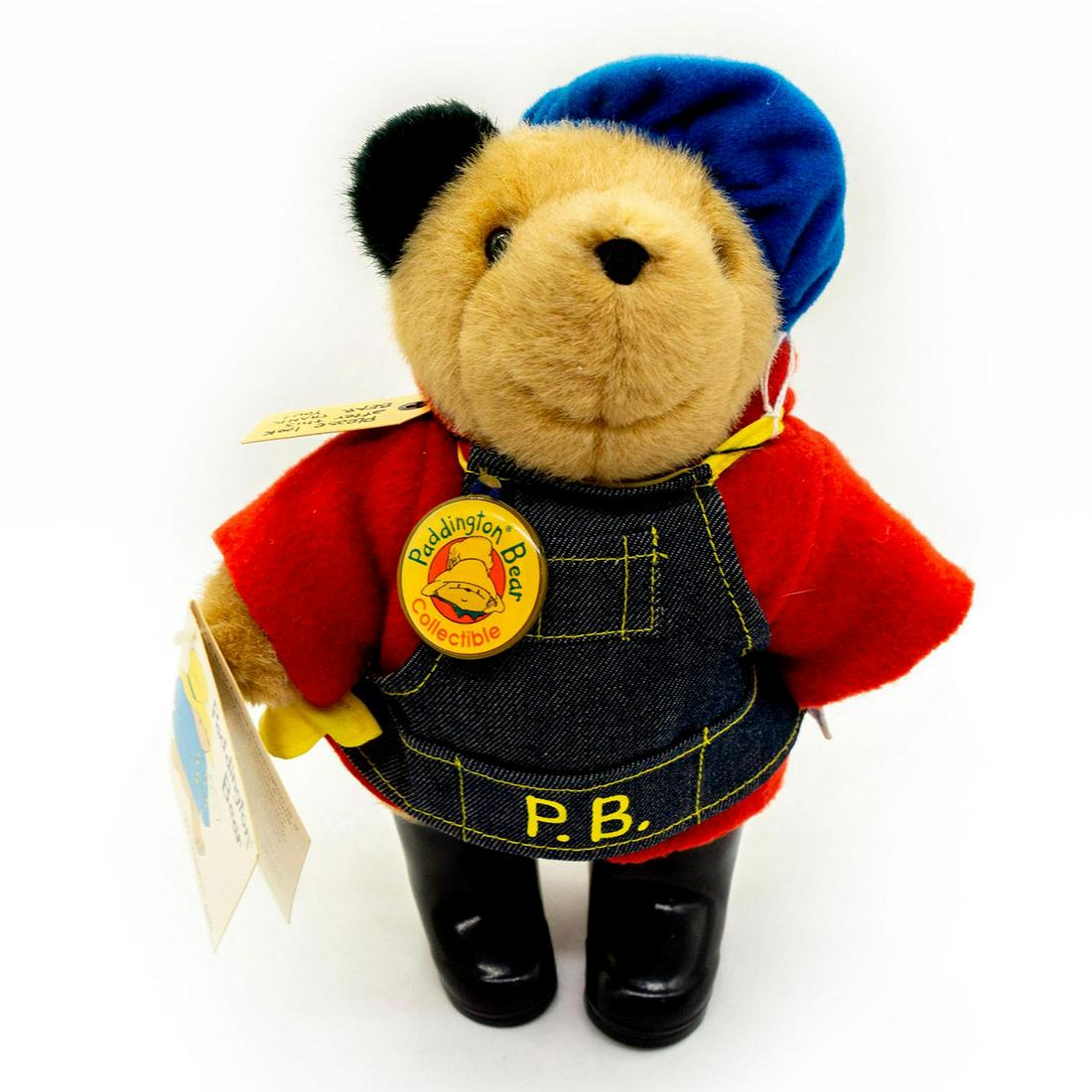 Paddington Bears Teddy Bear, Overalls: Plush, glass eyes, wearing a set of overalls and some black boots. Original tag attached. Under the overalls, which are marked P.B., is a red shirt and she is also wearing a blue hat. #paddingtonbears