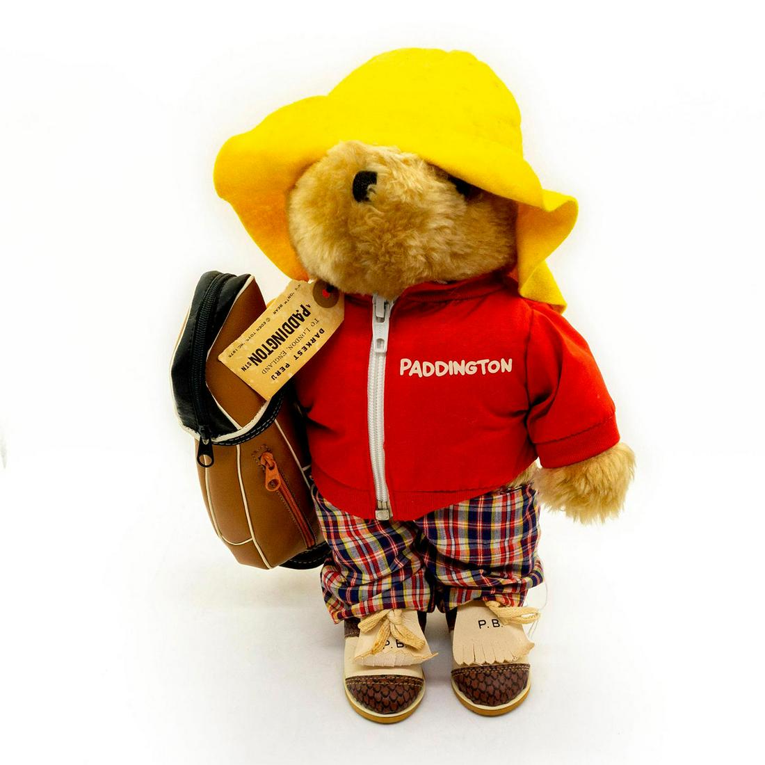 Paddington Bears Teddy Bear, The Golfer: Plush, glass eyes, sewn nose. Wearing a golfing outfit. Outfit comes with a stylish yellow hat, a jacket with Paddington's name on it, plaid pants, golf shoes, and a golf club bag. Original tag attach