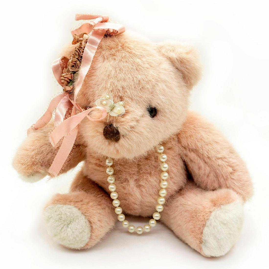 Vintage Collectable Teddy Bear, Pinky: Pink fur, glass eyes, stitched nose. Pink ribbons, pearl necklace, stylish butterfly broach. Manufacturer tag on back. Age related wear. #teddybear #plush #pink #jewelry Issued: 20th c. Dimensions: 9"