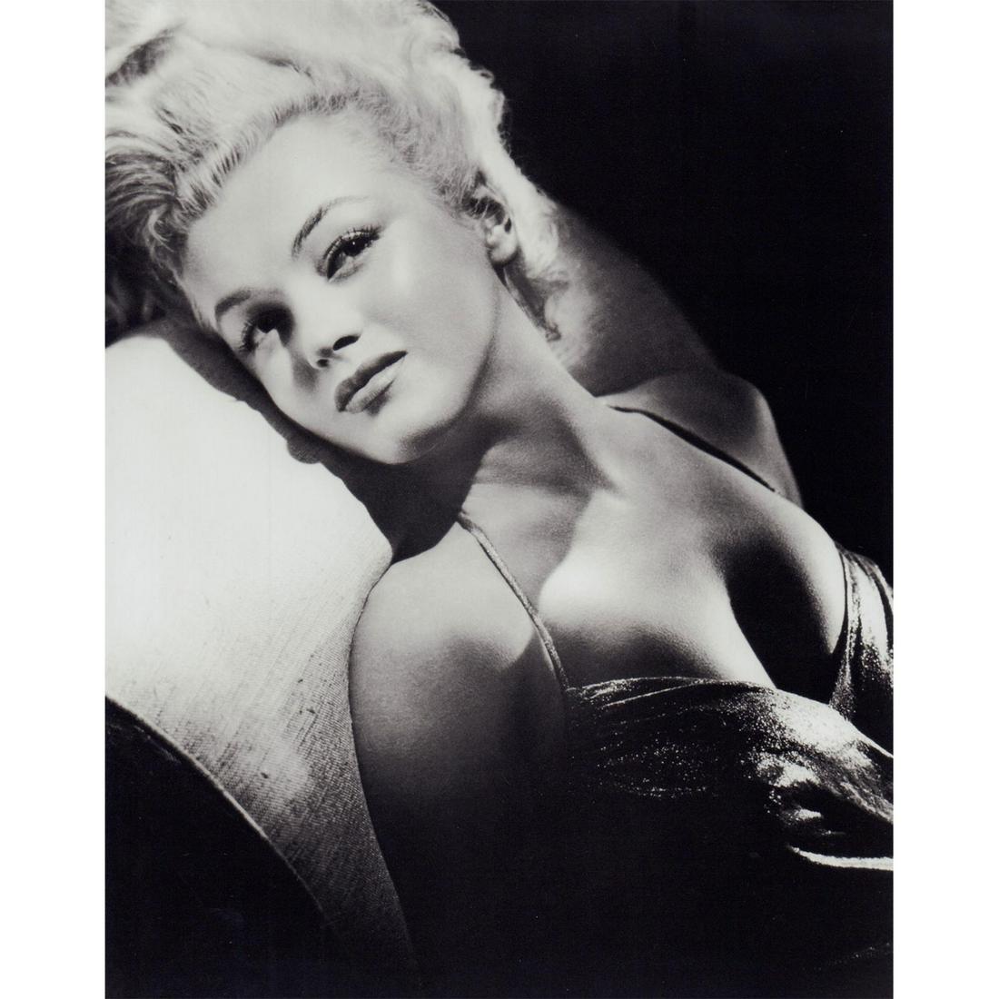 Marilyn Monroe Photograph: Portrait photo of Marilyn Monroe wearing shiny dress, leaning back on a couch. #marilynmonroe #oldhollywood Issued: c. 1950 Dimensions: 8"W x 10"H Country of Origin: USA