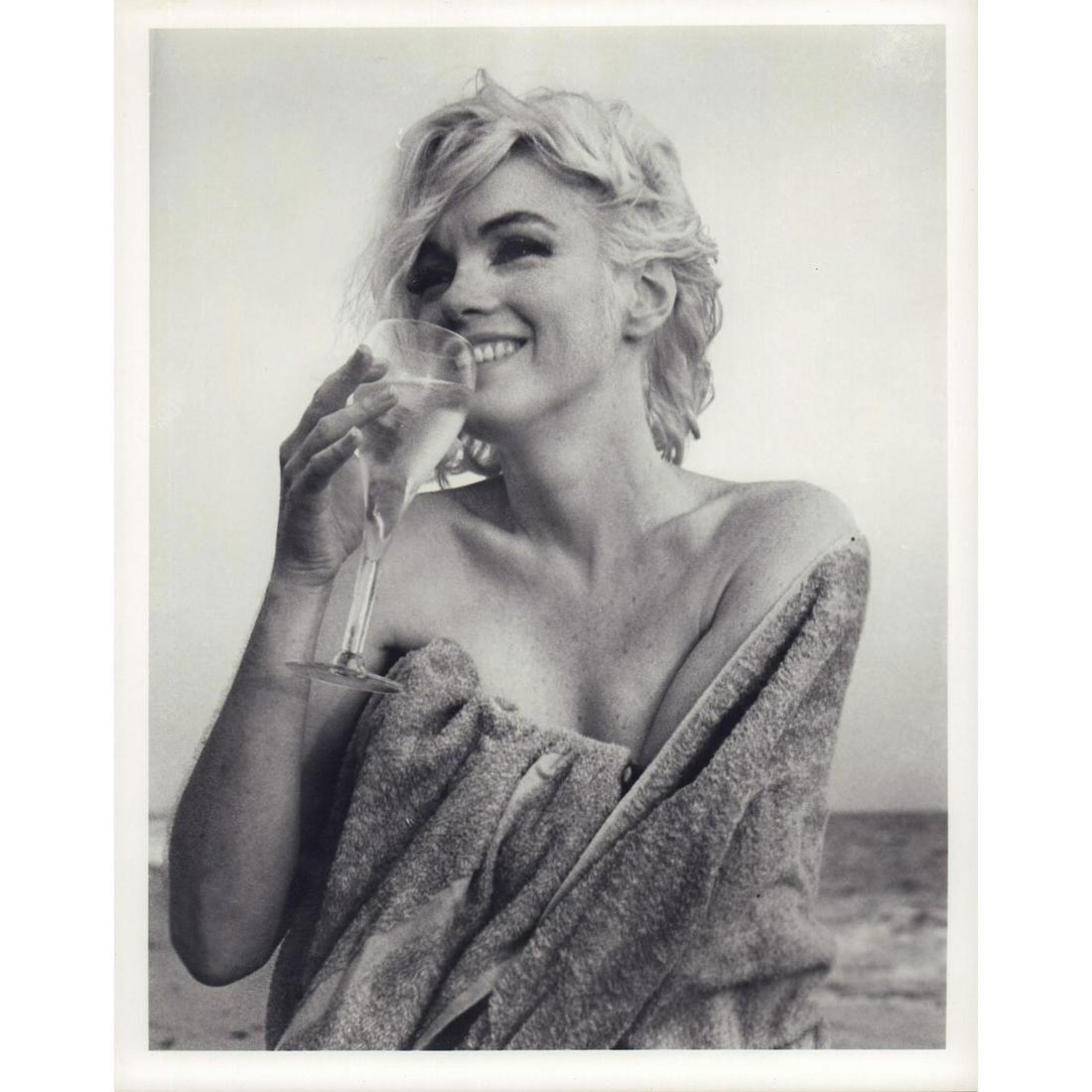 Marilyn Monroe Photograph: Portrait photo of Marilyn Monroe wrapped in a towel and holding a glass, on Santa Monica Beach, photographed by George Barris in 1962. #marilynmonroe #georgebarris #lastsitting Artist: George Barris I