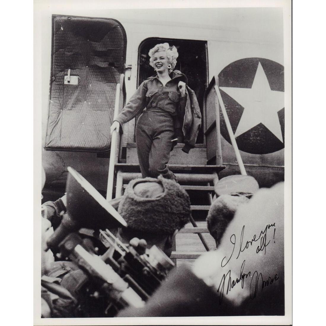 Marilyn Monroe Photograph: Photo of Marilyn Monroe stepping out of a C-54 airplane in Seoul, South Korea. Where she spent four days entertaining US troops during the Korean War. This is a reprint of an original signed photograp