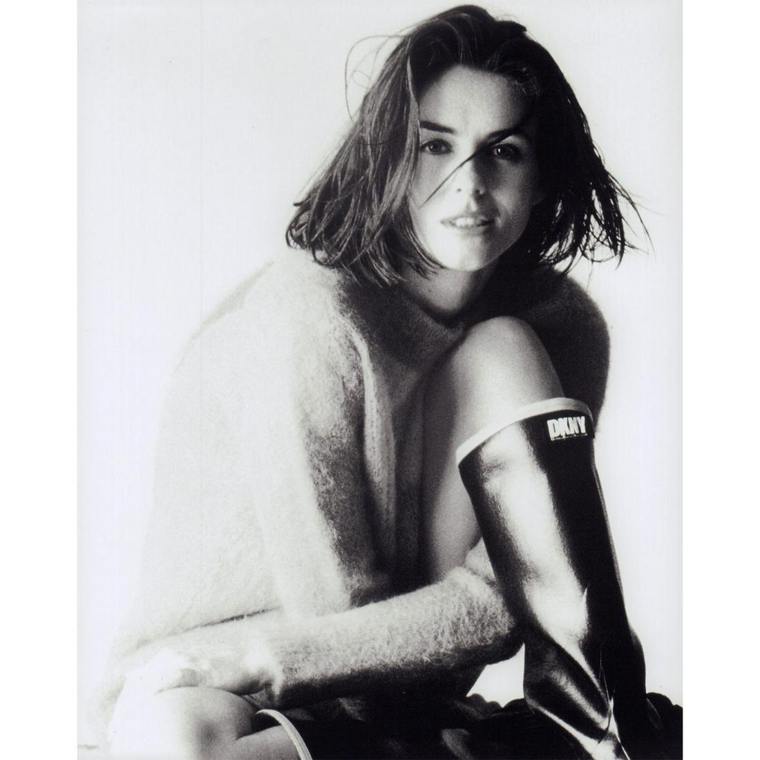 Celebrity Photograph: Black and white studio portrait of a woman wearing a fuzzy sweater and DKNY rain boots. #celebrityphoto #model #actress #dkny Issued: c. 1990 Dimensions: 8"W x 10"H