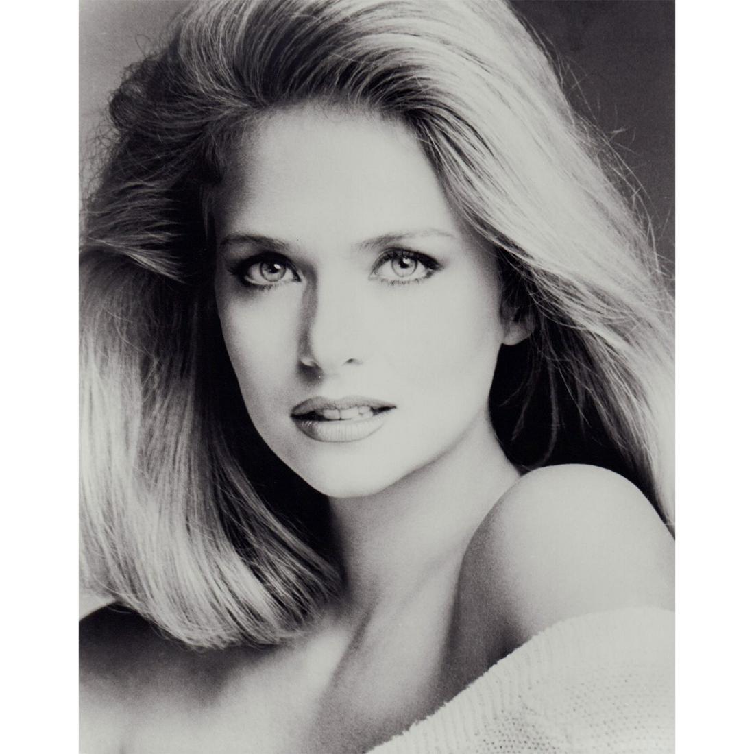 Donna Dixon Photograph: Black and white portrait photo of actress Donna Dixon wearing a white off-shoulder sweater. #donnadixon Issued: c. 1985 Dimensions: 8"W x 10"H Country of Origin: USA