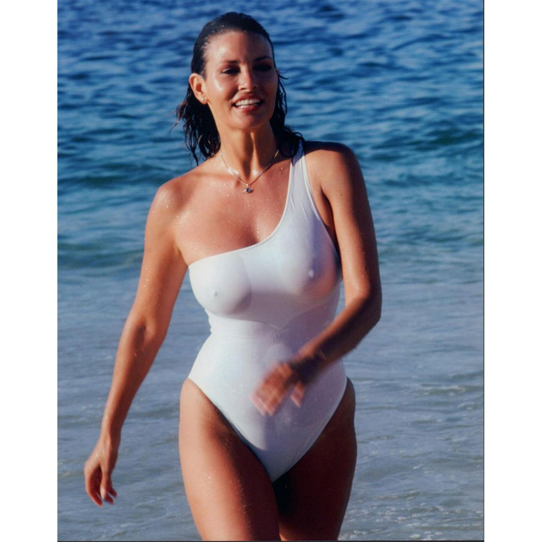 Raquel Welch Photograph: Photo of actress Raquel Welch wearing a white swimsuit on the beach in Cabo San Lucas, Mexico. Printed on Fujicolor Professional paper. #raquelwelch #celebrityphoto Issued: 1980 Dimensions: 8"W x 10"H