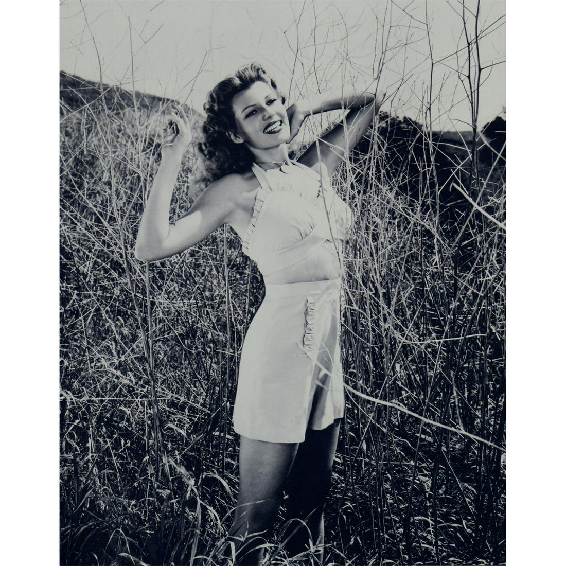 Rita Hayworth Photograph: Black and white photo of Rita Hayworth, wearing a 2-piece outfit in a field of tall grass. Printed on Fujicolor Crystal Archive paper. #ritahayworth #oldhollywood Issued: c. 1945 Dimensions: 8"W x 10"