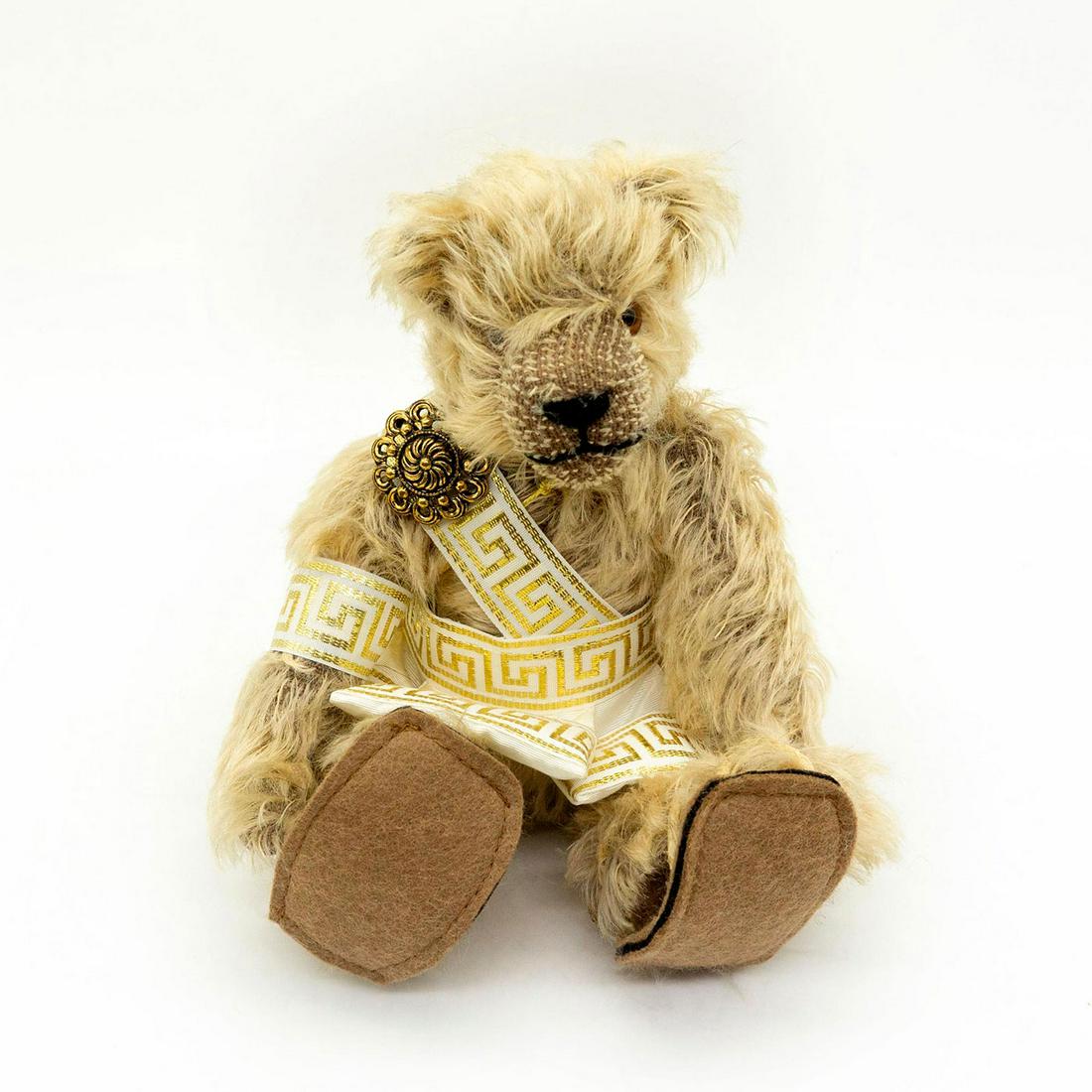 Hermann, The Epoche Bears Perikles Teddy Bear: Limited edition of 28 of 1,000. Fully jointed. Constructed with mohair. Perikles is wearing white and gold colored tunic and cloak. Comes with original tag. The tag says "With the construction of the 