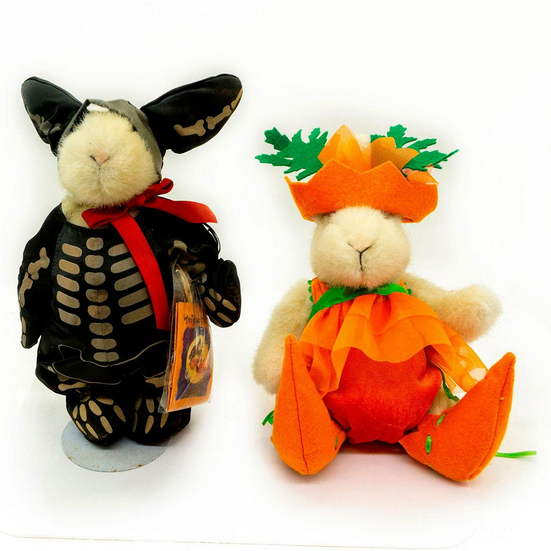 2 North American Bear Plush Rabbits, Halloween Costumes: One in full body black skeleton costume. Other in bright orange and green pumpkin costume. Hoppy VanderHare collection. Jointed limbs. Original tags attached. One comes with stand. Age related wear. M