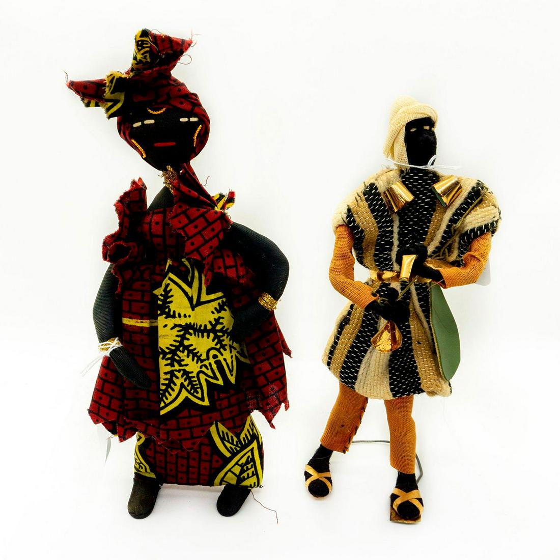 2pc Handmade African Folk Art Souvenir Dolls: Vintage souvenir dolls most likely from Africa. Hand stitched faces. Metal wire stands attached to the feet. Measurements Female doll - 11"H. Male doll - 10.5H. Missing a shoe sole. Shows some natural