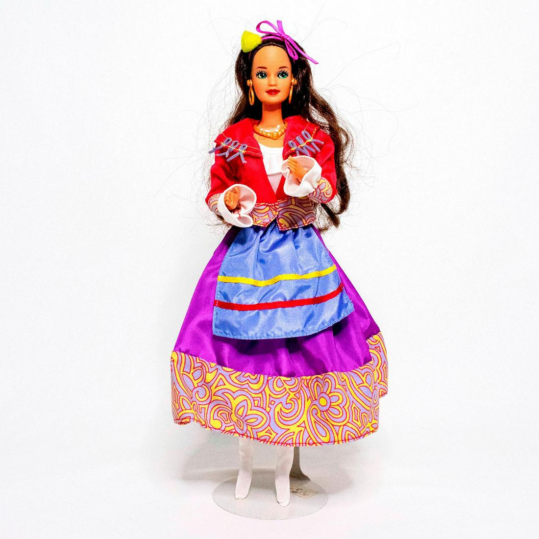 Mattel Barbie Doll, 2nd Edition Italian: Barbie doll wears a colorful costume traditionally worn by Neapolitan dancers in the city of Naples. Her white peasant blouse is topped by a colorful jacket, skirt, and apron. A single flower, tied wi