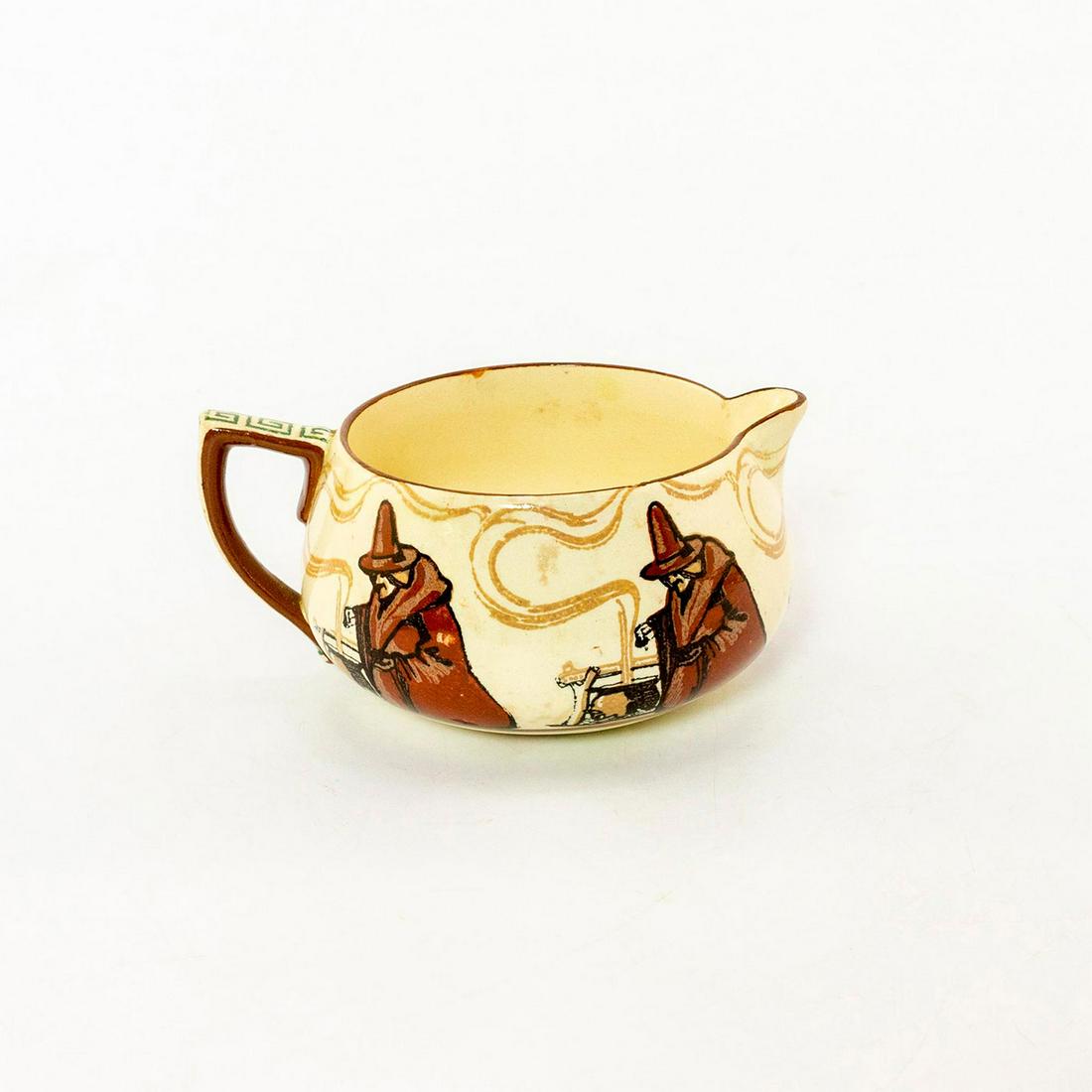 Royal Doulton Seriesware Creamer, Witches: Brown and cream coloration; glazed ceramic; encircling witches on body. Doulton backstamp. Age related crazing. Issued: 20th c. Dimensions: 4.5"L Manufacturer: Royal Doulton Country of Origin: England