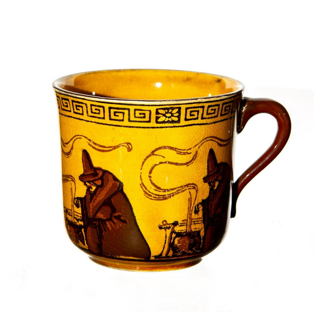 Royal Doulton Seriesware Cup, Witches: Ochre tone ceramic cup; encircling repeated design of a witch. Doulton backstamp. Age related crazing. Issued: 20th c. Dimensions: 2.75"H Manufacturer: Royal Doulton Country of Origin: England