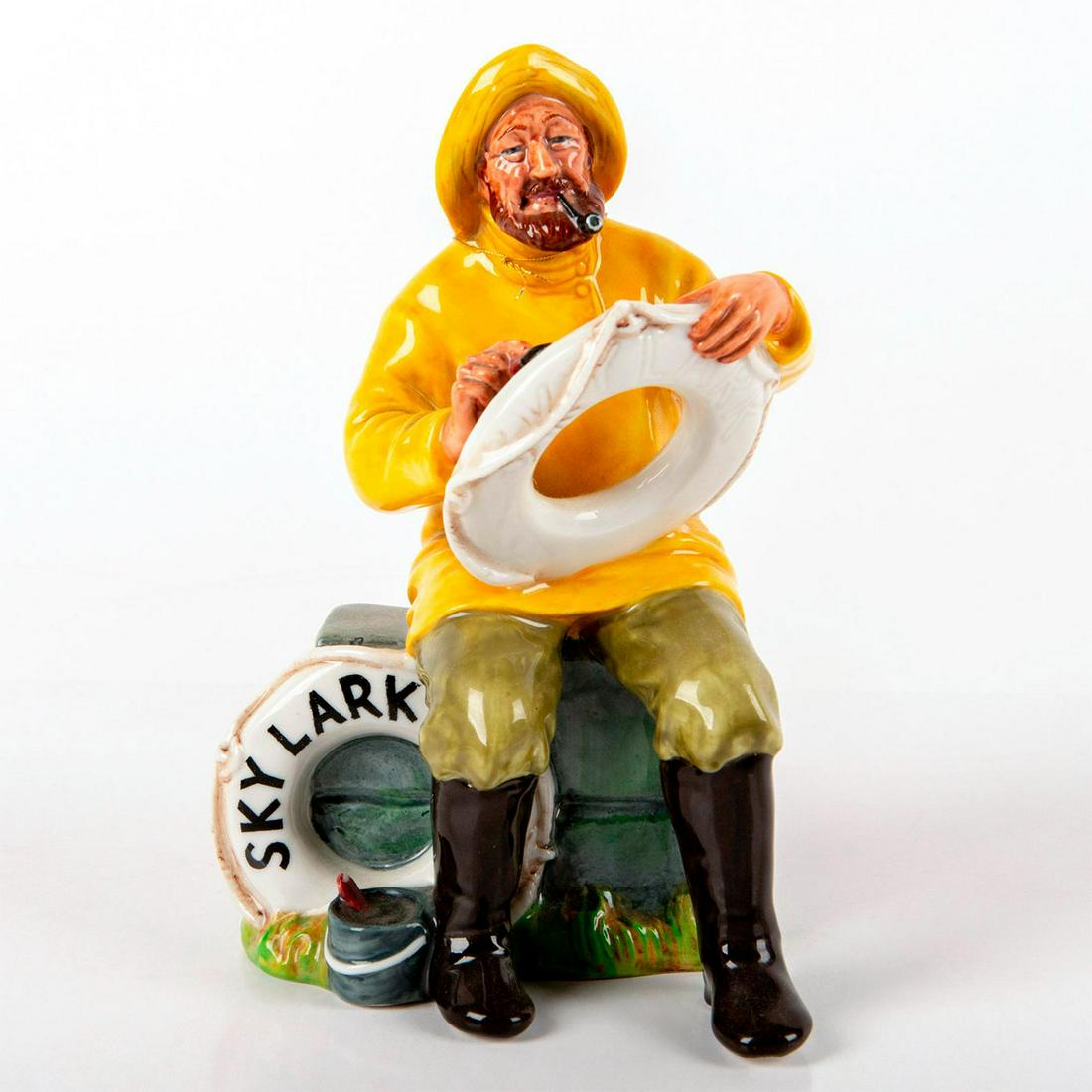 Boatman (Skylark) HN2417 - Royal Doulton Figurine: Seated in man in bright yellow shirt, olive green pants and black boots. When he is not doing odd jobs or running local boat trips, the Boatman spends his time telling tales of his adventures at sea t