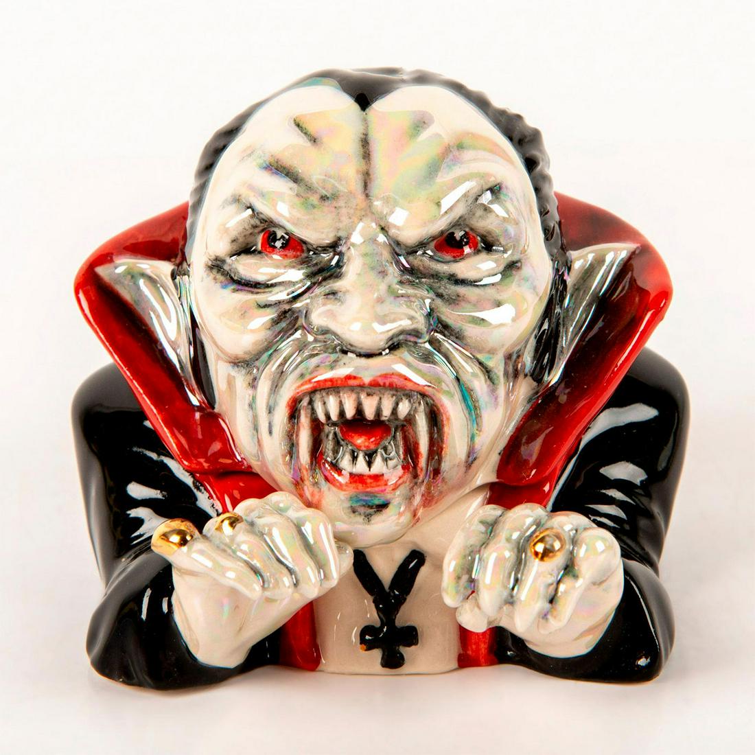 Kevin Francis Face Pots, Count Dracula: Black and red cape suit with pointy teeth and red mouth and eyes. Face and hands are glazed iridescent over gray. Limited edition number 65 of 225. Inside quote; " Count Dracula Bite Me!" Kevin Franci