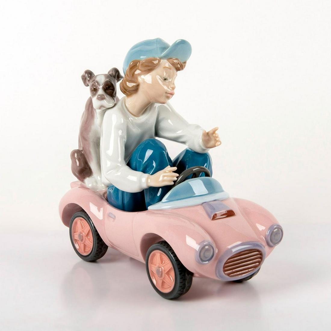 Out for a Spin 1005770 - Lladro Porcelain Figurine: A boy and his dog sit in a tiny toy car. Glazed finish. Comes with original box. Lladro backstamp. Good condition. Artist: Joan Coderch Issued: 1991 - 1994 Dimensions: 6.75"H Manufacturer: Lladro Coun