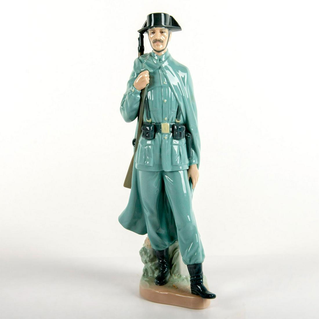 Spanish Policeman 1004889 - Lladro Porcelain Figurine: Glossy finish in blue-grey coloration, modeled as a Spanish policeman in uniform. With box. Lladro backstamp. Artist: Salvador Furio Issued: 1974-2002 Dimensions: 11.75"H x 4.375"W Manufacturer: Lladr