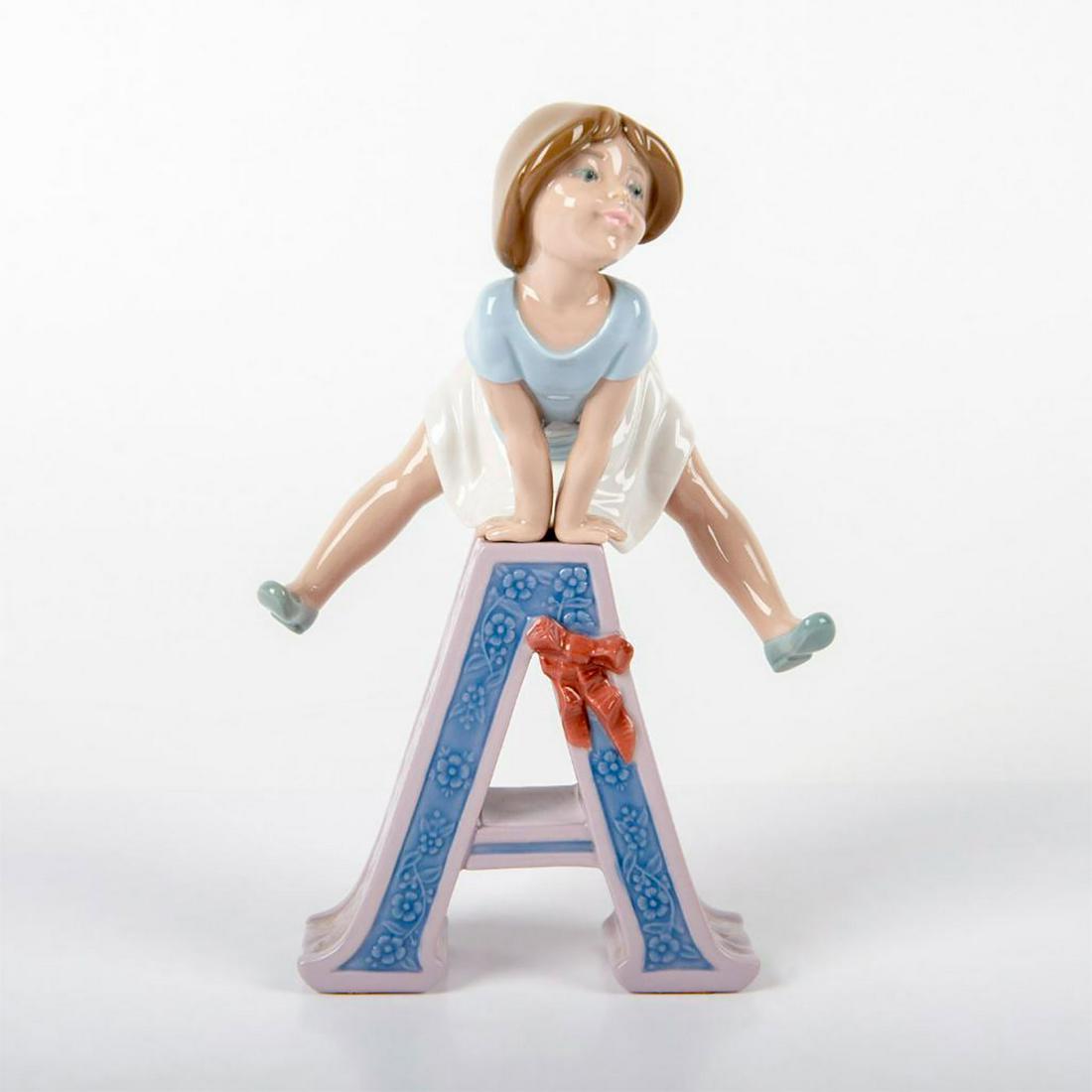 Schoolgirl A 1005145 - Lladro Porcelain Figurine: Glossy porcelain; girl with letter A. Lladro backstamp. No box. Artist: Jose Puche Issued: 1982 Dimensions: 8.25"H Manufacturer: Lladro Country of Origin: Spain