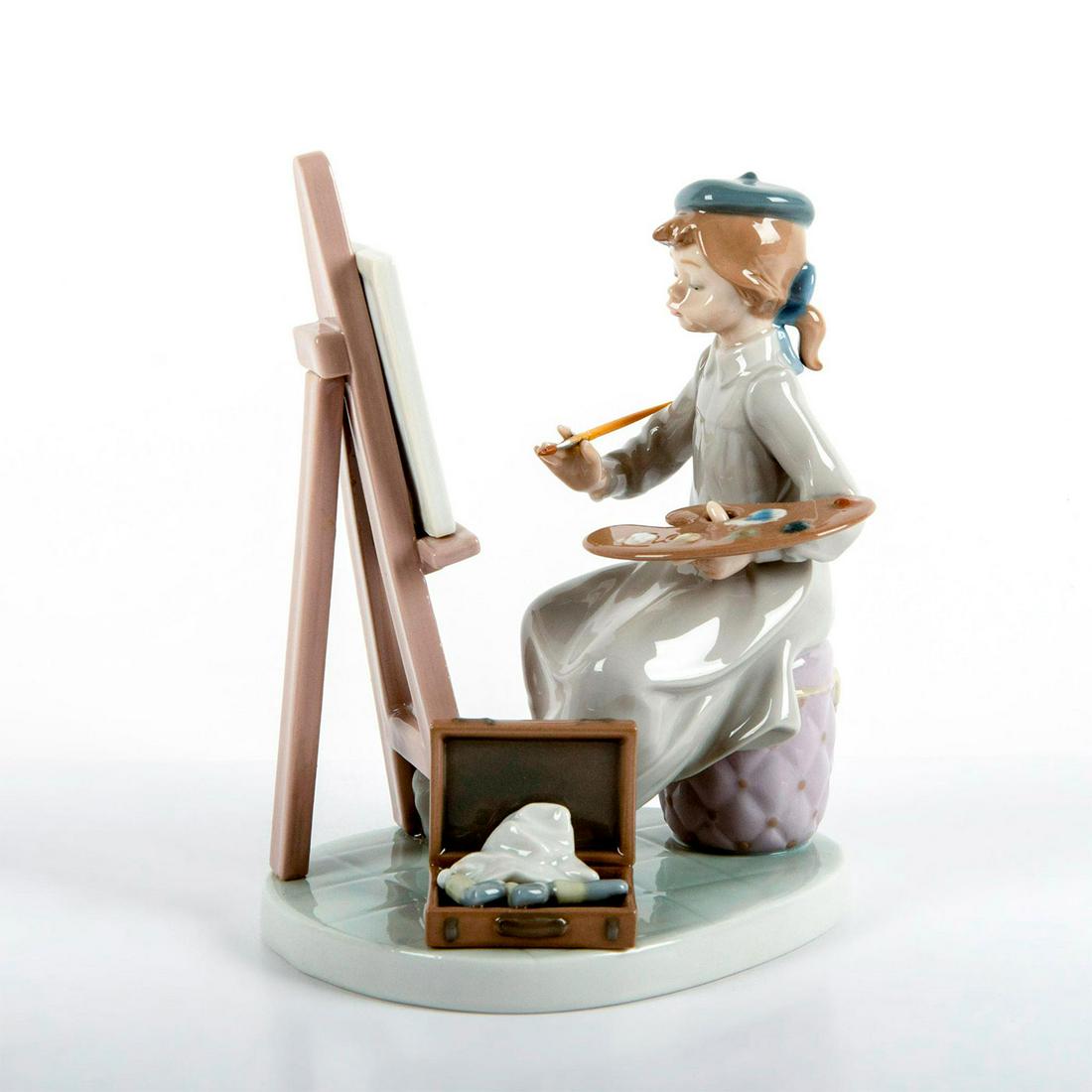 Still Life 1005363 - Lladro Porcelain Figurine: Glossy finish; Girl sitting in front of easel, painting. Lladro backstamp. Original box included. Artist: Antonio Ramos Issued: 1986 - 1997 Dimensions: 6.75"H x 5.5"W Manufacturer: Lladro Country of O