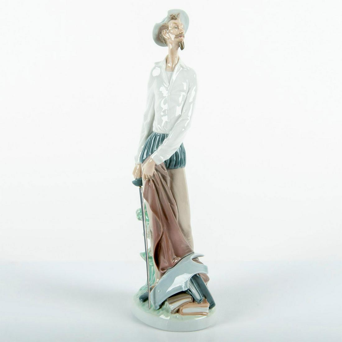 Quixote Standing Up 01004854 - Lladro Porcelain: Glossy finish; Don Quixote standing with sword in hand. Lladro backstamp. Original box included. Artist: Salvador Furio Issued: 1973 Dimensions: 11.75"H x 4"W Manufacturer: Lladro Country of Origin: S