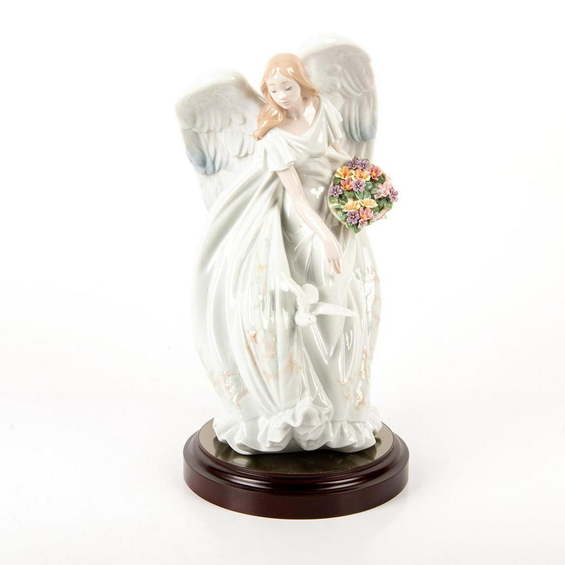 Flowers of Peace 01001867 LTD - Lladro Porcelain: Glazed, woman bending over to touch dove. Long flowing dress. Includes base and certificate of authenticity. Artist signature. Artist: Virginia Gonzalez Issued: 2001-2004 Dimensions: 13"H x 8.75"W Edi