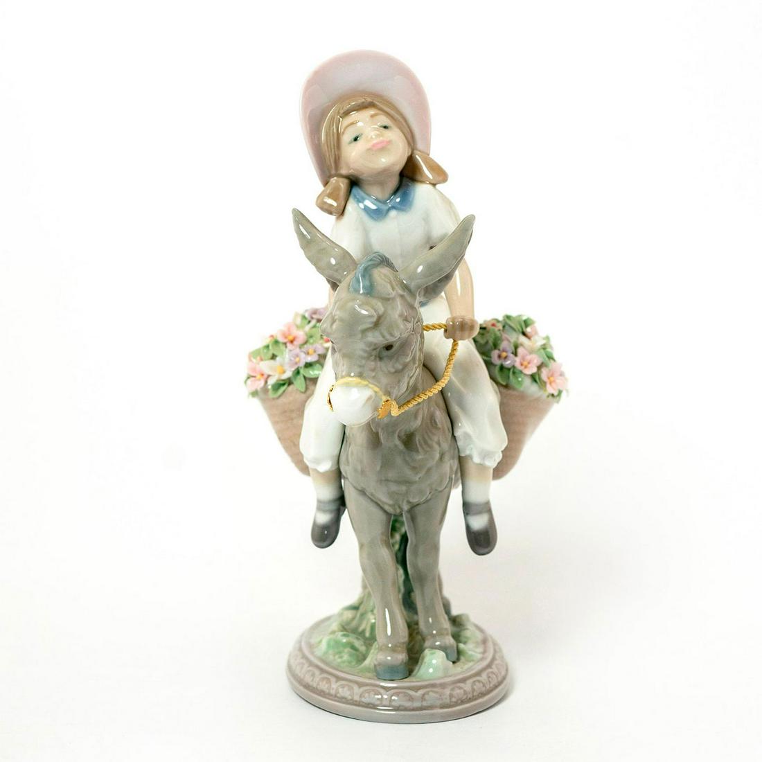 Look At Me! 1005465 - Lladro Porcelain Figurine: Glazed; Young girl riding donkey with flowers. With original box. Missing flowers. Lladro backstamp. Artist: Jose Puche Issued: 1988-2004 Dimensions: 7.75"H x 5.5"W Manufacturer: Lladro Country of Ori