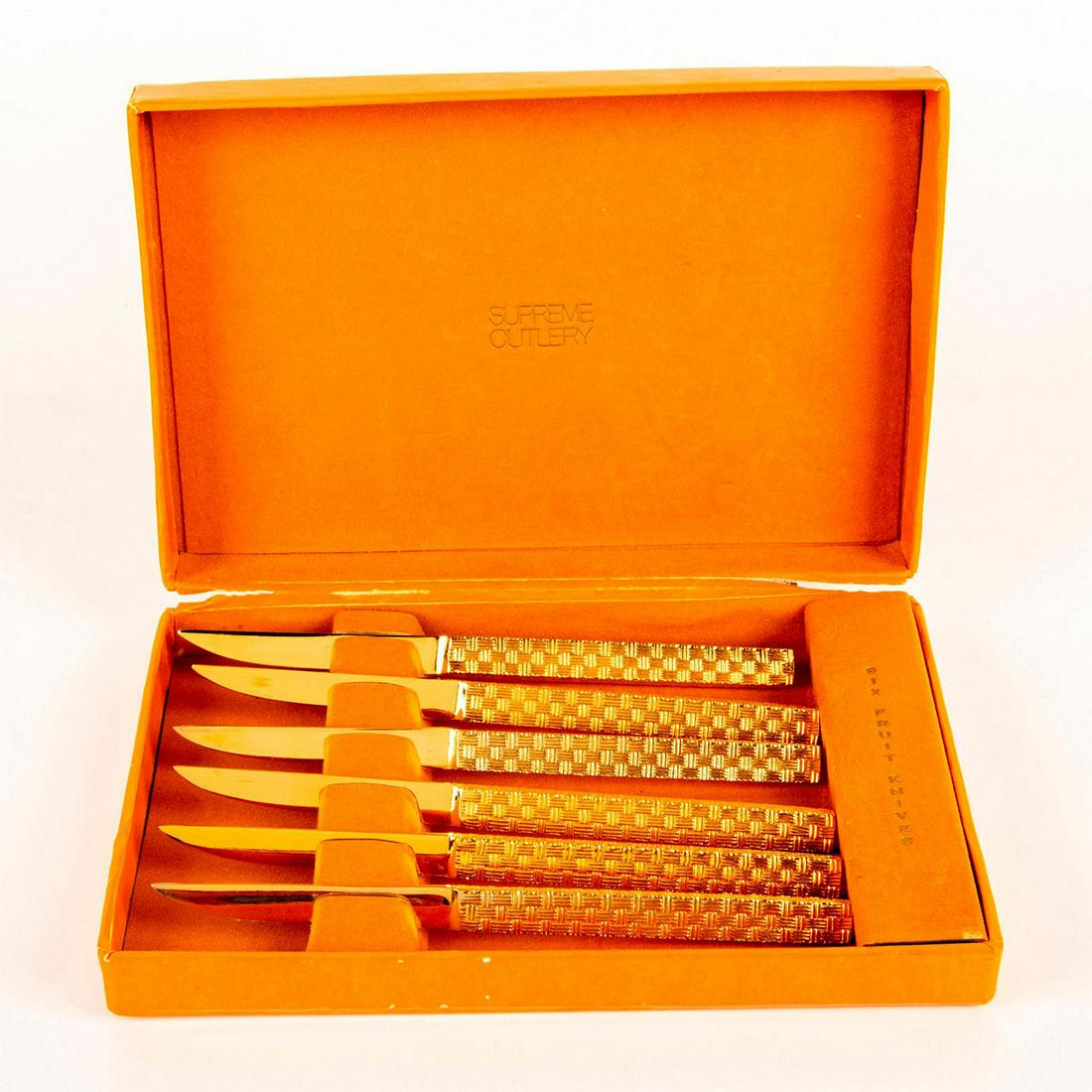 Supreme Cutlery, 6 Gold Toned Fruit Knives: Set of 6 gold toned fruit knives. Crisscross pattern on handles Comes in the original box. Box measurements - 7.75"W x 5.25"L x 1.5"H. Show signs of usage. Some scratches on the blades. #silverware #c