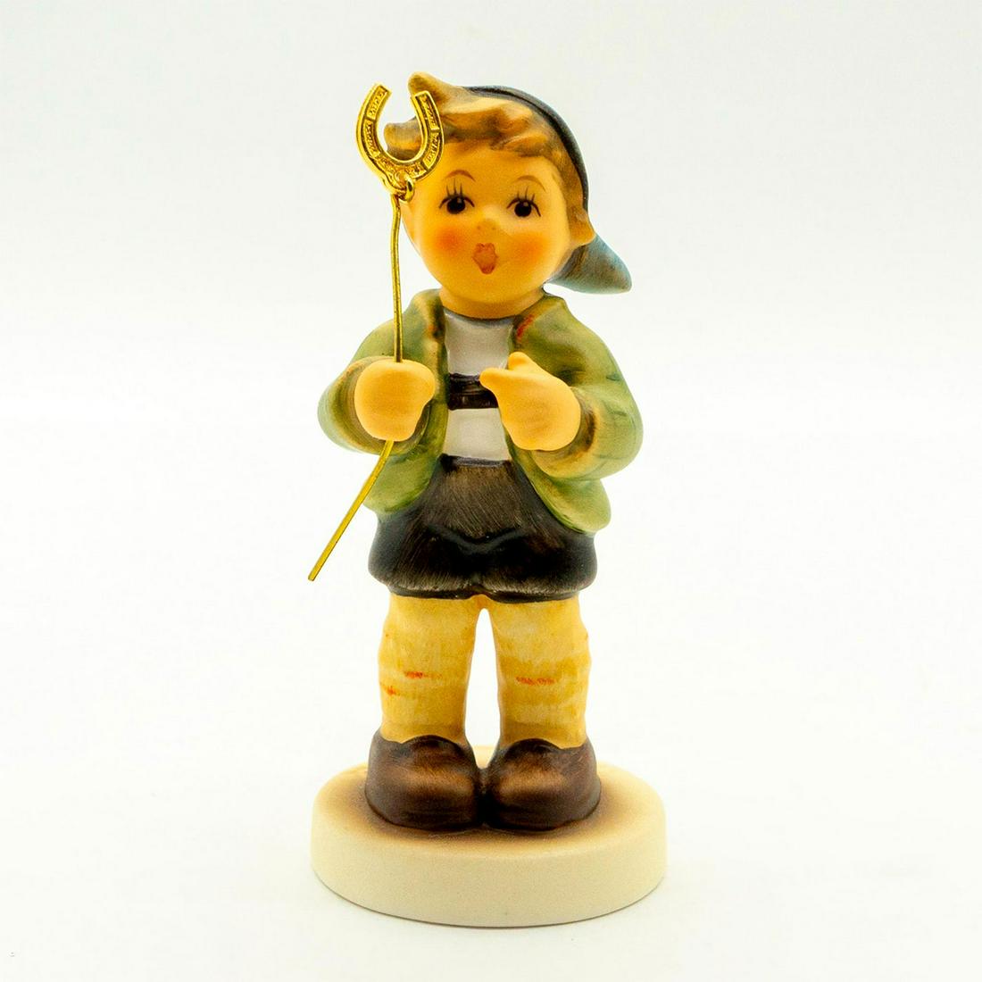 Little Luck 2296 - Goebel Hummel Figure: Matte porcelain, hand painted. 2010 exclusive for Hummel Club members. 'M. I. Hummel' inscribed on base. Goebel backstamp. Good condition. #goebel #hummel #figurine #hummelclub Issued: 2008 Dimensions