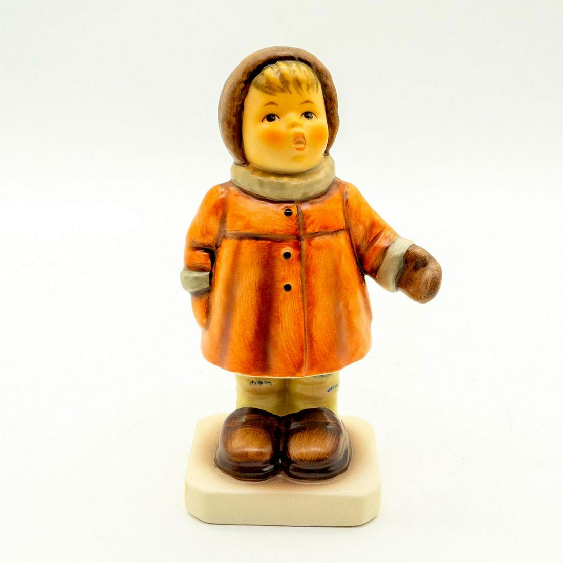 Winter Song 476 - Goebel Hummel Figure: Matte porcelain, hand painted. Young girl in orange coat, brown hood, and brown mittens. 'M. I. Hummel' inscribed on base. Goebel backstamp. Good condition. #goebel #hummel #figurine #vintage Issued: