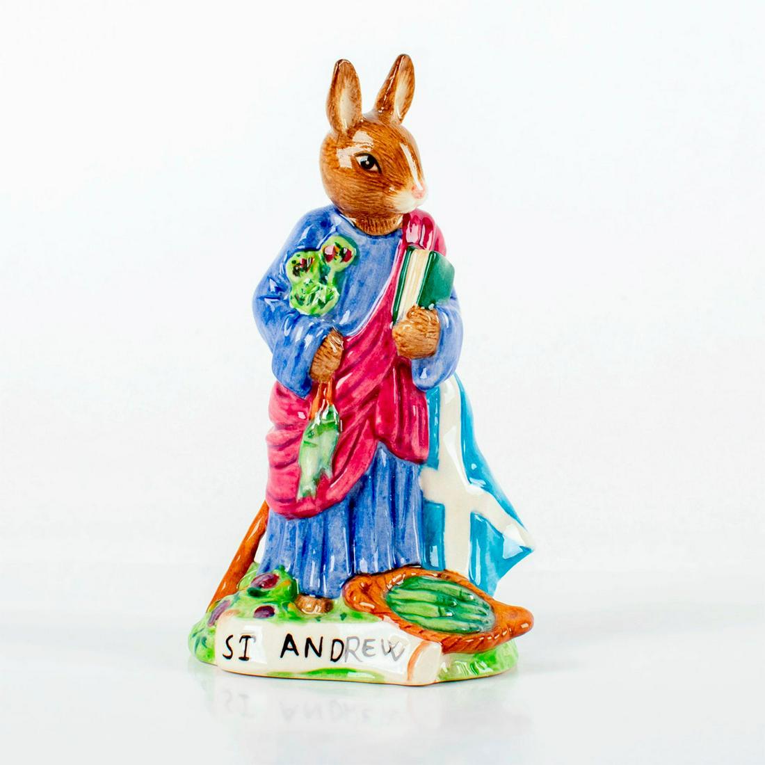 St. Andrew DB399 - Royal Doulton Bunnykins: Patron Saints Collection. Brown bunny wearing blue and purple robes, with the flag of Scotland. Bunnykins backstamp. Limited edition number 373 of 1000 pieces. Original box and certificate included. #