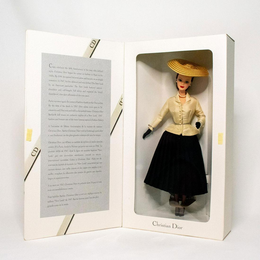 Mattel Barbie Doll, Christian Dior: Barbie is wearing Dior's famed New Look silhouette, featuring narrow shoulders and calf-length full skirts that created an international sensation. Barbie's look is complete with a Parisian straw hat,