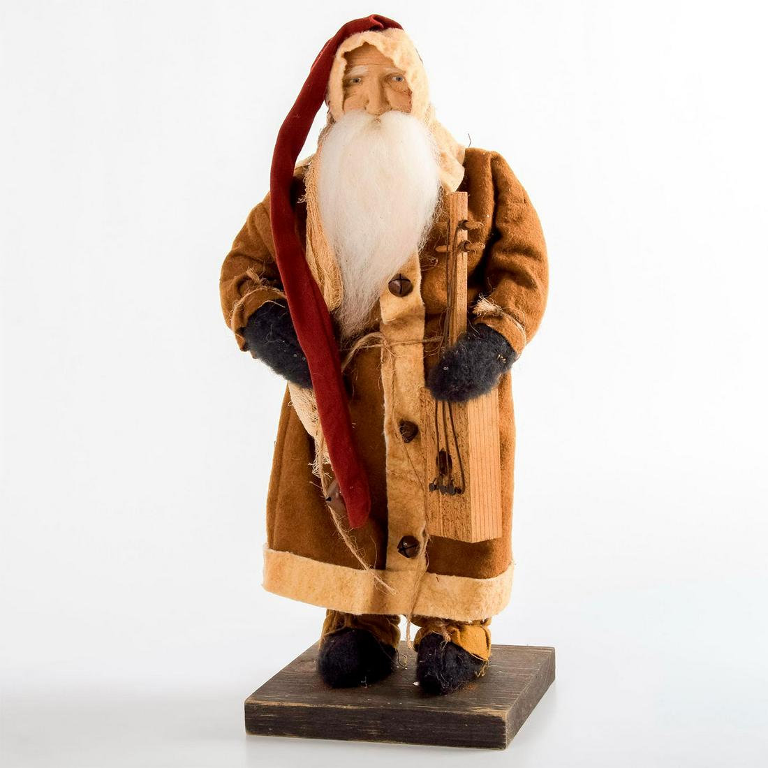 Arnett's Country Store, Santa Doll with Banjo: Hand crafted 14.75" tall Santa doll. Beige pants, long brown coat and red hat with a bell. Holding a wooden Banjo. Since 1976, Arnettâ€™s Country Store, Made in USA stamped on the bottom. Age rel