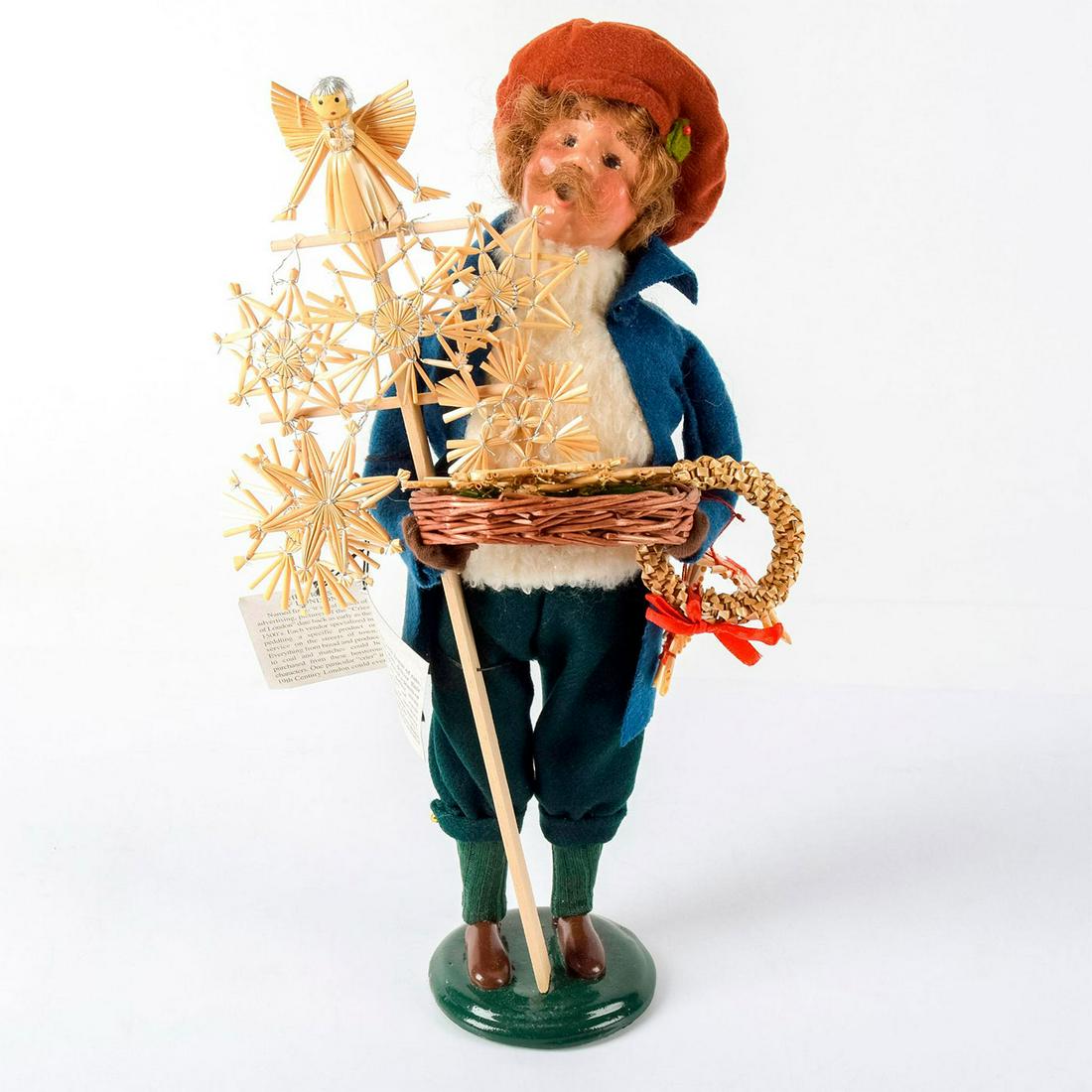 Byers Choice Figurine, The Carolers, Straw Ornament: The Cries of London series handcrafted figure. A man selling lovely Christmas straw ornaments. Whit sweater and blue jacket. Handcrafted clay face and hand-made clothes. Byers Choice backstamp. Comes 