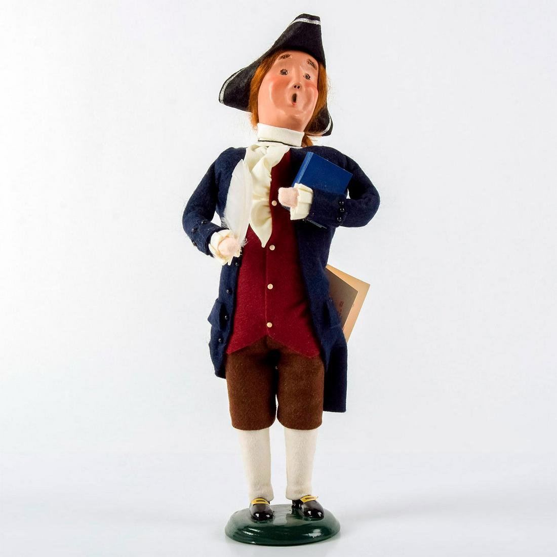 Byers Choice Figurine, Williamsburg Thomas Jefferson: Handcrafted Williamsburg Christmas series figurine of Thomas Jefferson. Blue jacket and red vest. Holding book and quill pen. Handcrafted clay face and hand-made clothes. Byers Choice backstamp. Comes