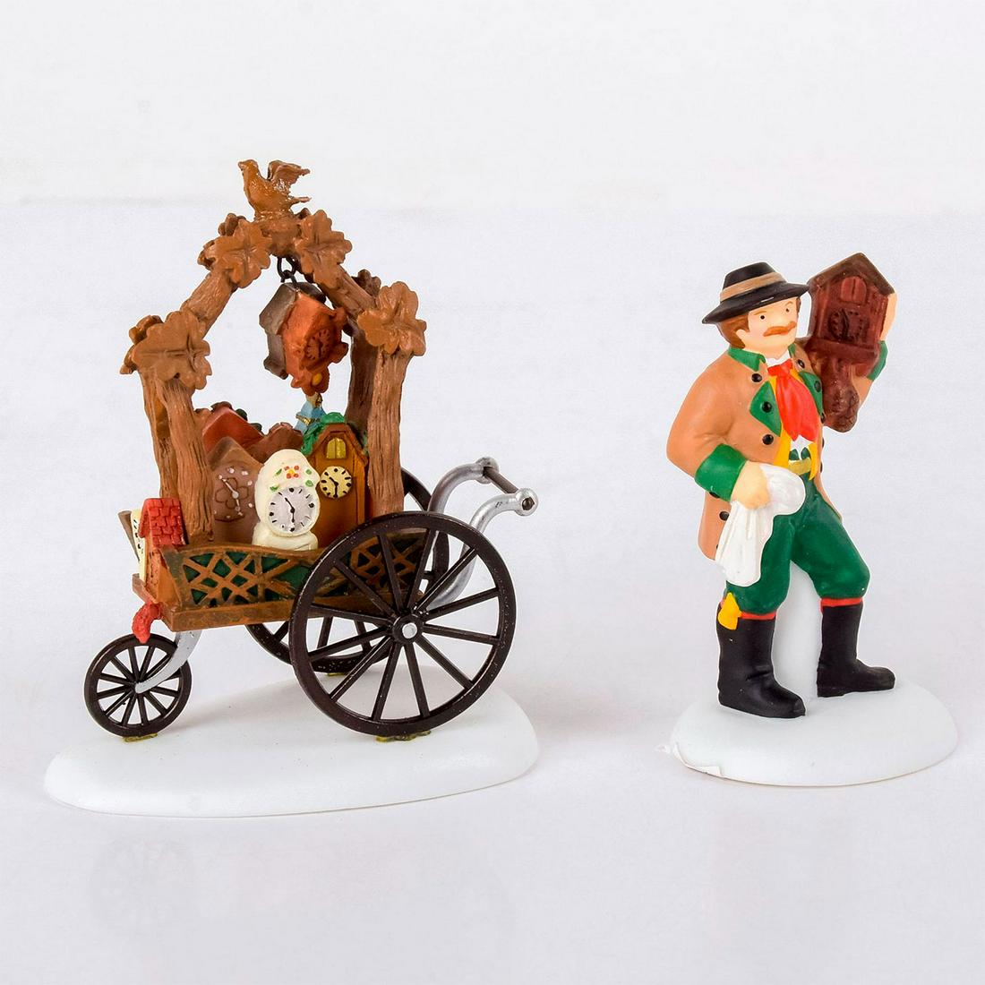 Department 56 Figurine, Alpine Village Clock Vendor and: Man in green, yellow and red suit with wooden clocks on a cart. Depratment 56 Impressed in the bottom. With original box. #department56 #alpinevillage #christmas #clockvendor Issued: 2001-2004 Dimensi