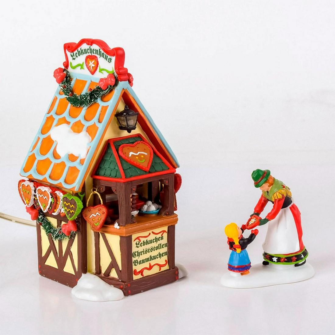 Set Of 2 Department 56 Figures, Gingerbread Booth: Handpainted porcelain; comes with lighted gingerbread booth figure and figurine of market seller and customer. The Heritage Village Collection, Alpine Village Series. With original box. Department 56 
