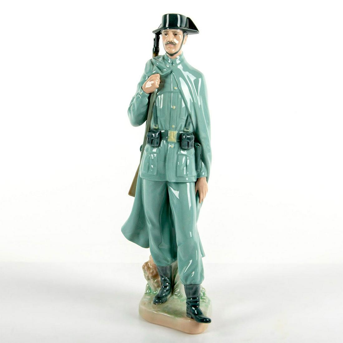 Spanish Policeman 1004889 - Lladro Porcelain Figurine: Glossy finish in blue-grey coloration, modeled as a Spanish policeman in uniform. With box. Lladro backstamp. Artist: Salvador Furio Issued: 1974-2002 Dimensions: 11.75"H x 4.375"W Manufacturer: Lladr