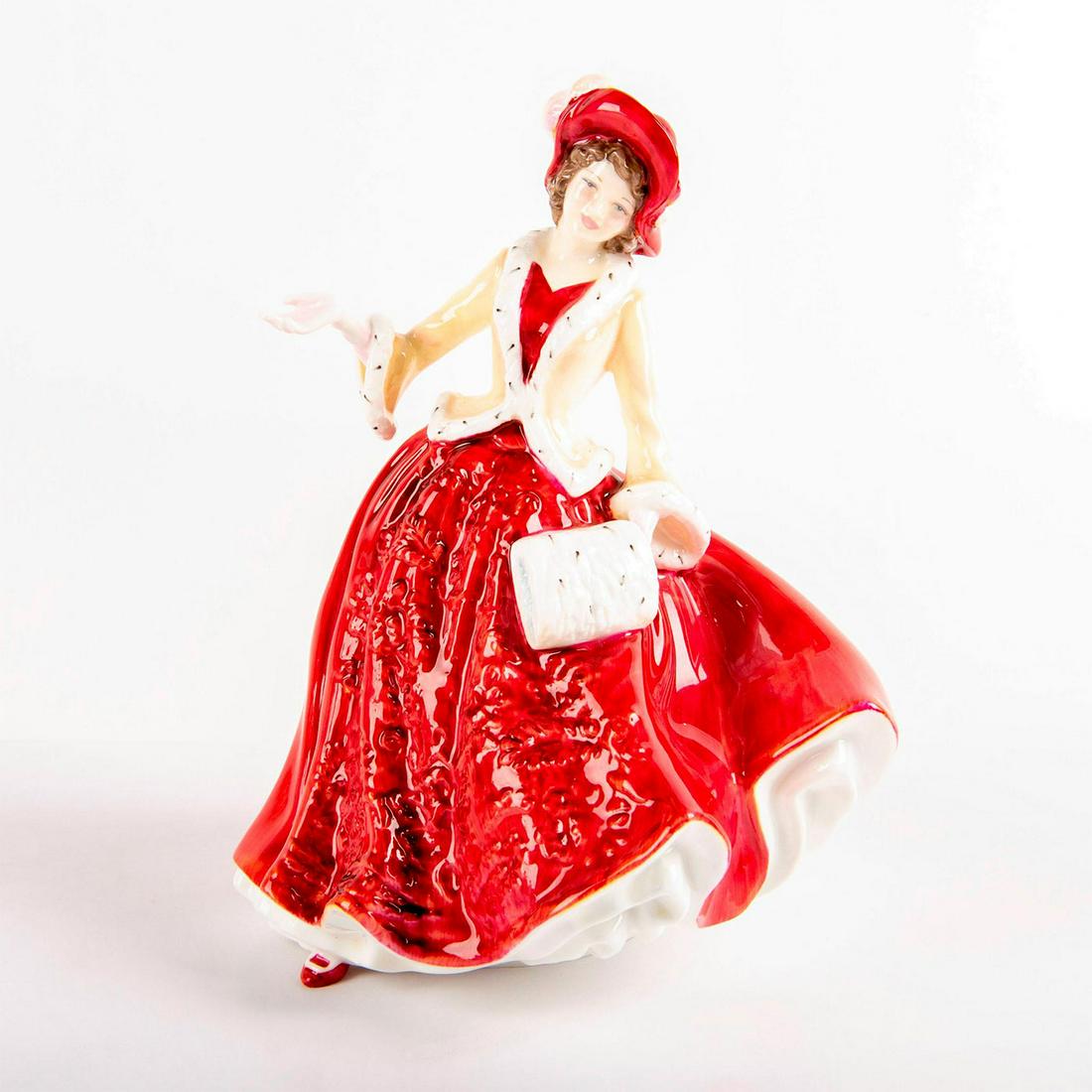 Christmas Day 1999 HN4214 - Royal Doulton Figurine: Bone China. Red dress with relief pattern, matching hat, and yellow jacket with fur lining. Series: Christmas Day Figures. Royal Doulton backstamp. Artist: Nada Pedley Issued: 1999 - 1999 Dimensions: 