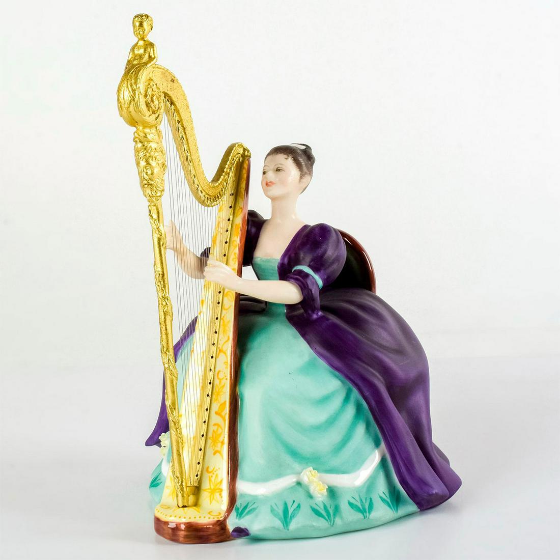 Harp HN2482 - Royal Doulton Figurine: She wears a purple and green 18th-century gown, while playing an ornate gold harp. The Lady Musicians series was characterized by its graceful and elegant reflection of the styles of 18th-century musi