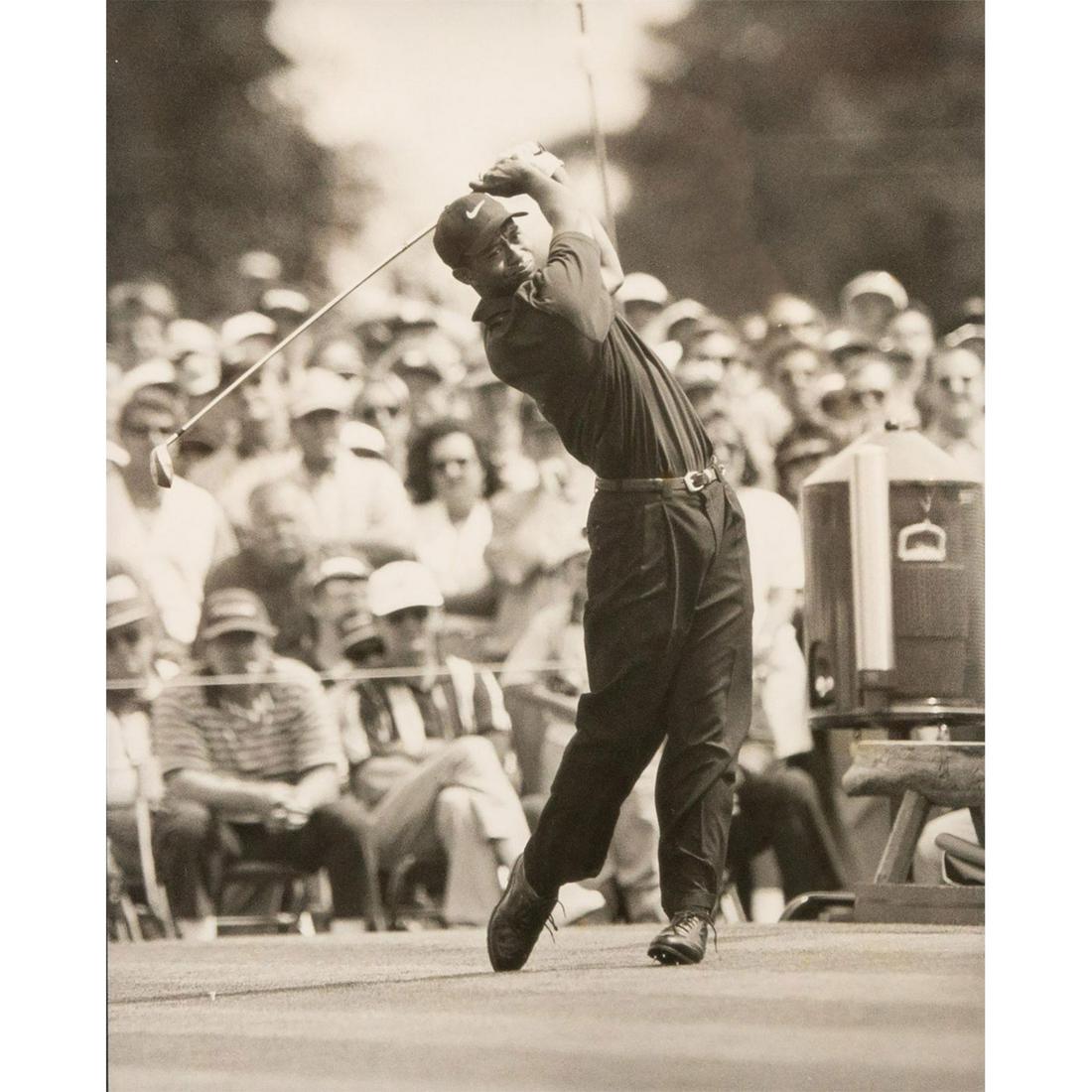 Black and White Photography, Tiger Woods: Black wood frame. Photograph of Tiger Woods's golf swing during tournament. No photographer signature. Some visible scratches on frame. Sight size - 10"H x 8"W. Frame size - 15.25"H x 17.25"W. Issued: