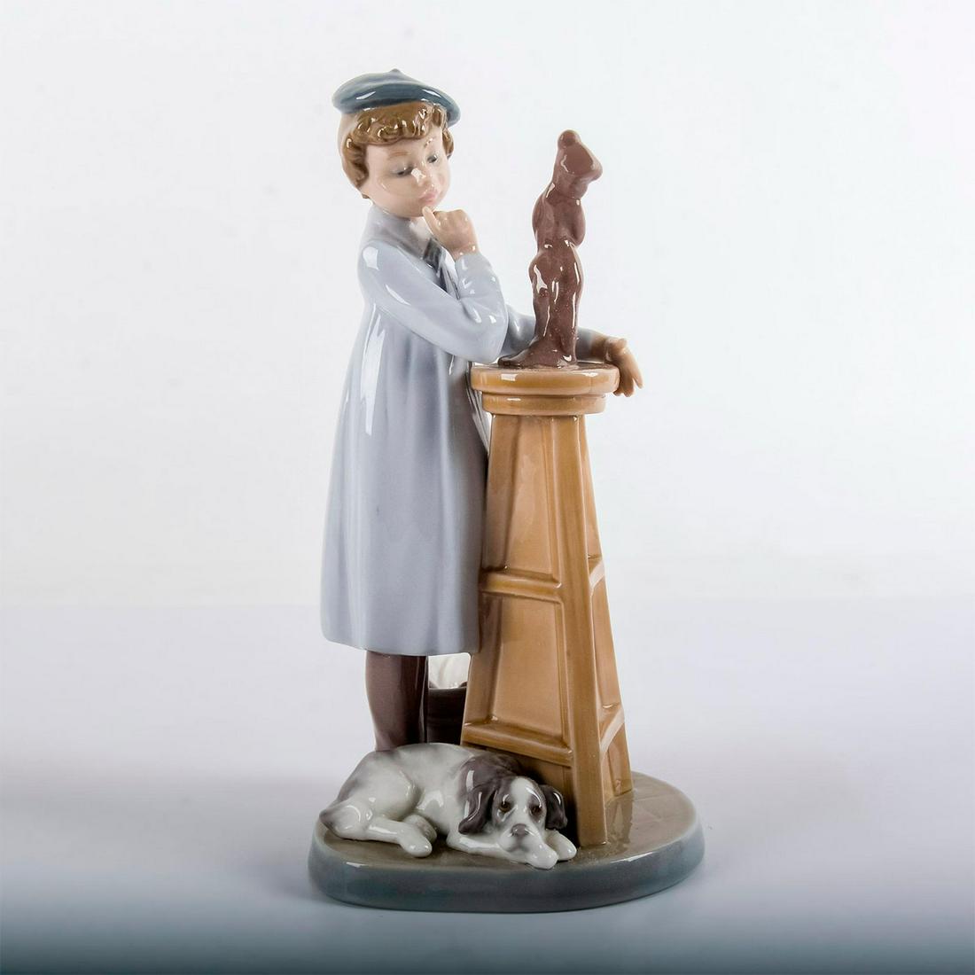 Little Sculptor 1005358 - Lladro Porcelain Figurine: Young girl in blue beret next to pedestal displaying her latest sculpture. Without original box. Lladro backstamp. Artist: Antonio Ramos Dimensions: 8.25"H Issued: 1986 - 1989 Manufacturer: Lladro Cou