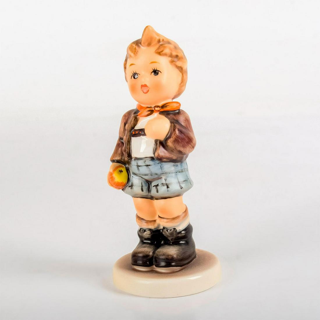 Cheeky Fellow 554 - Goebel Hummel Figurine: Matte porcelain, hand painted. Young boy in lederhosen holding an apple in his right hand. With original box and certificate of authenticity. 'M. I. Hummel' inscribed on base. 1992/1993 exclus
