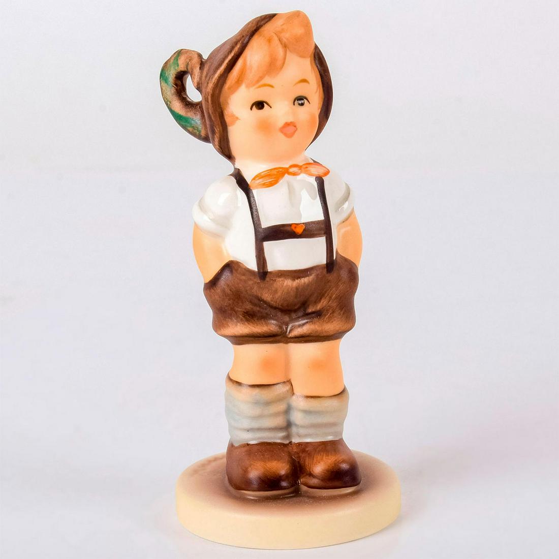 For Keeps 630 - Goebel Hummel Figurine: Matte porcelain, hand painted. Joyous young boy in overalls with hands in pockets. 'M. I. Hummel' inscribed on base. Underside reads 'M. I. Hummel Club, Membership Year 1994/95.' Goebe