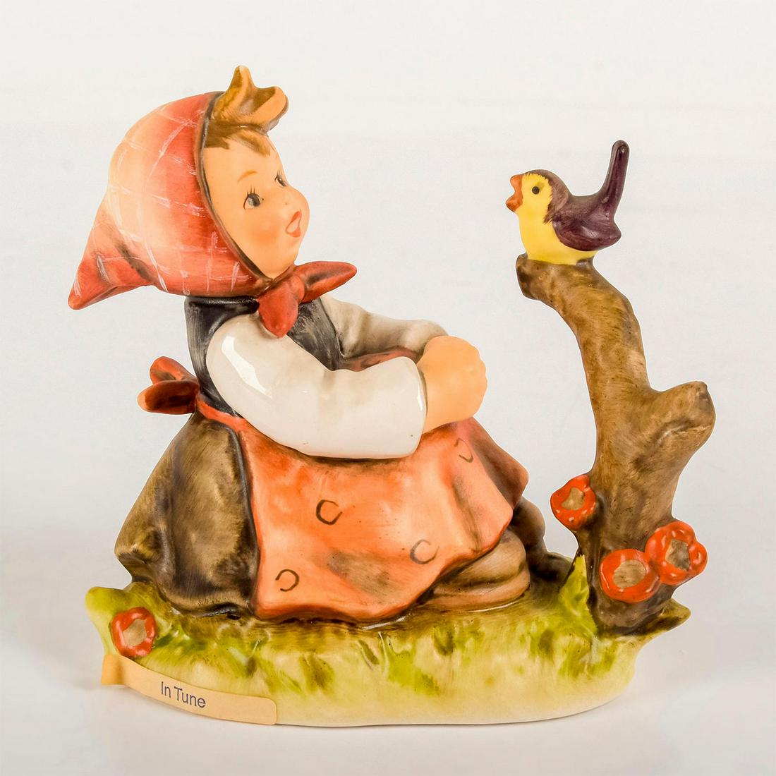 In Tune 414 - Goebel Hummel Figurine: Matte porcelain, hand painted. Young girl in bonnet and apron singing with a small bird. 'M. I. Hummel' inscribed on base. Goebel backstamp. Good condition. #goebel #hummel #figurine Dimension