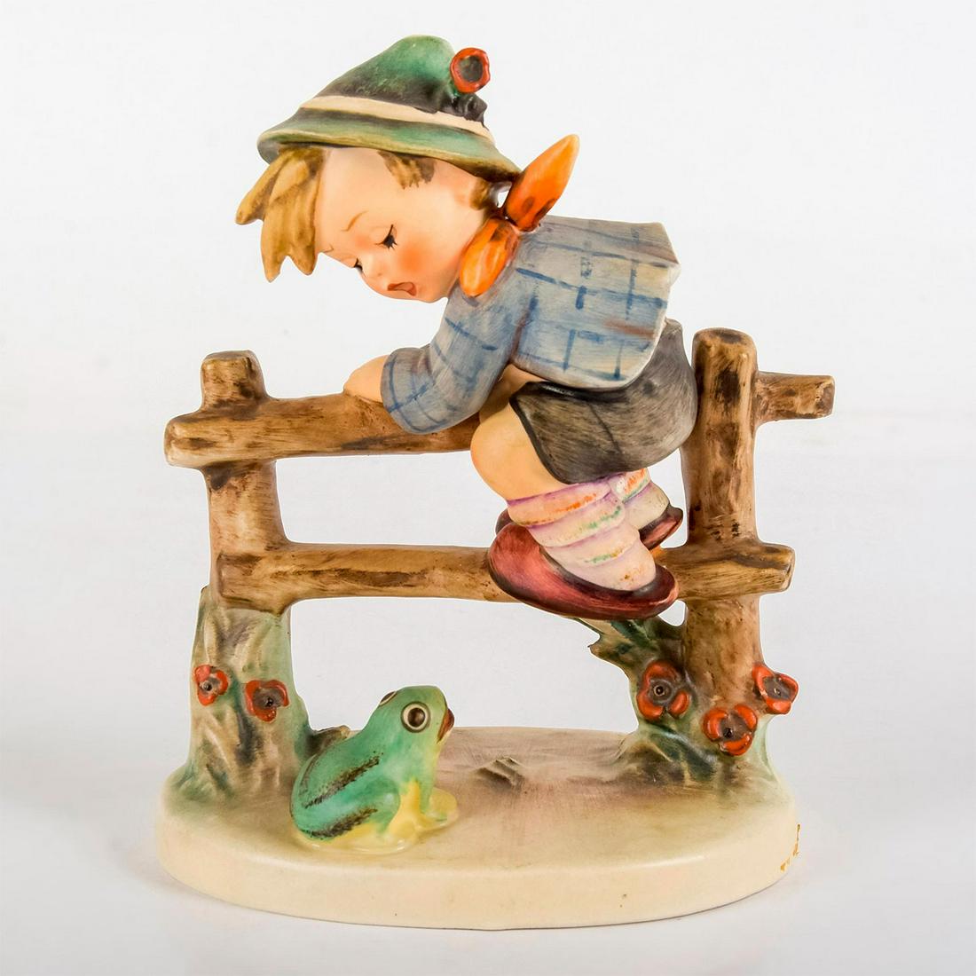 Retreat To Safety 201I - Goebel Hummel Figurine: Matte porcelain, hand painted. Startled boy scaling a fence to escape an interested frog. 'M. I. Hummel' inscribed on base. Goebel backstamp. Good condition. 1948 is impressed on underside, bu