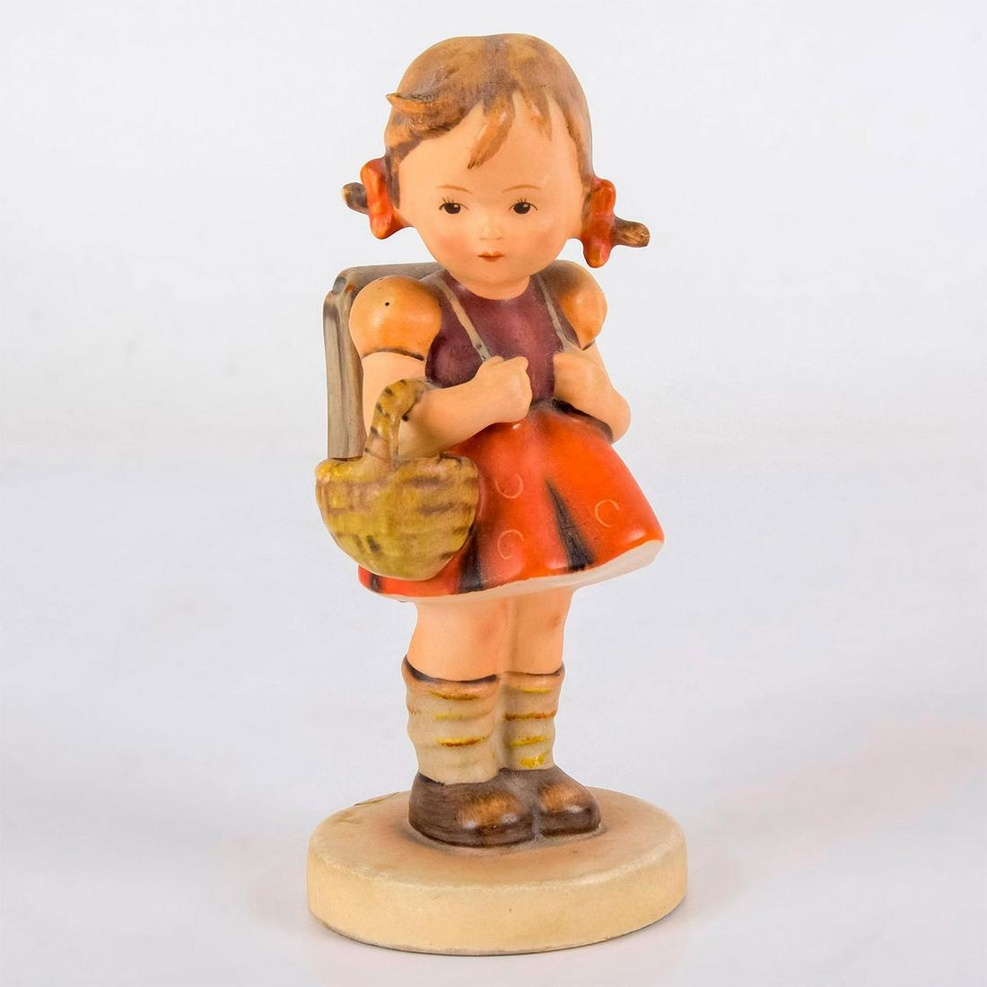 Schoolgirl - Goebel Hummel Figurine: Cute, vintage figure of a Girl with schoolbag-Title schoolgirl. The schoolgirl holds the basket on her hand while carrying a school back-bag. Artist: MJ Hummel Dimensions: 5.25"H Issued: 1960s Manufac