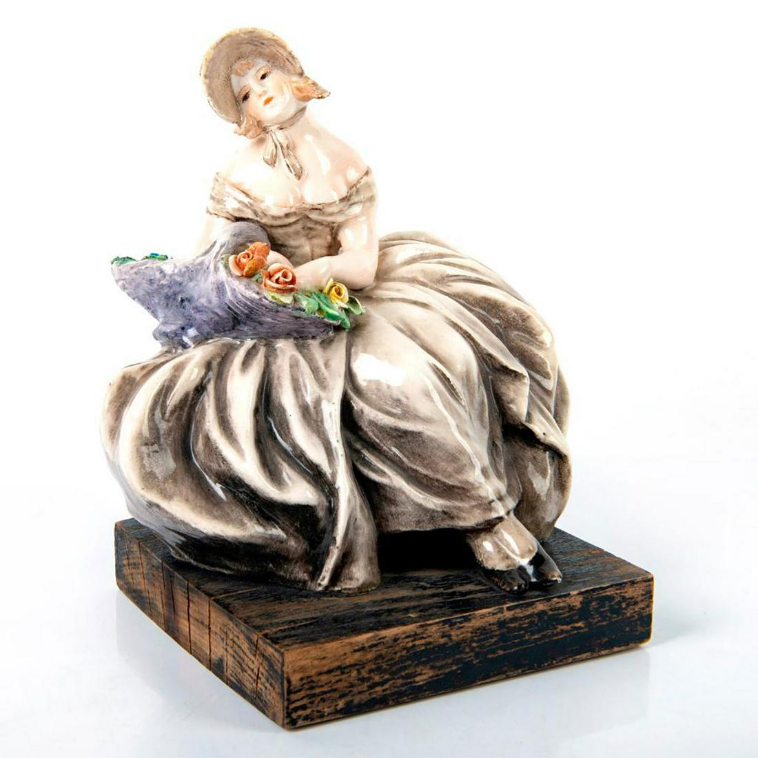 Vintage Italian Figurine, Woman With Flowers: Seated woman with basket of flowers; mounted wooden base. Attributed to Guido Cacciapuoti. Age related wear. Dimensions: 7.75"H Issued: 20th c. Country of Origin: Italy