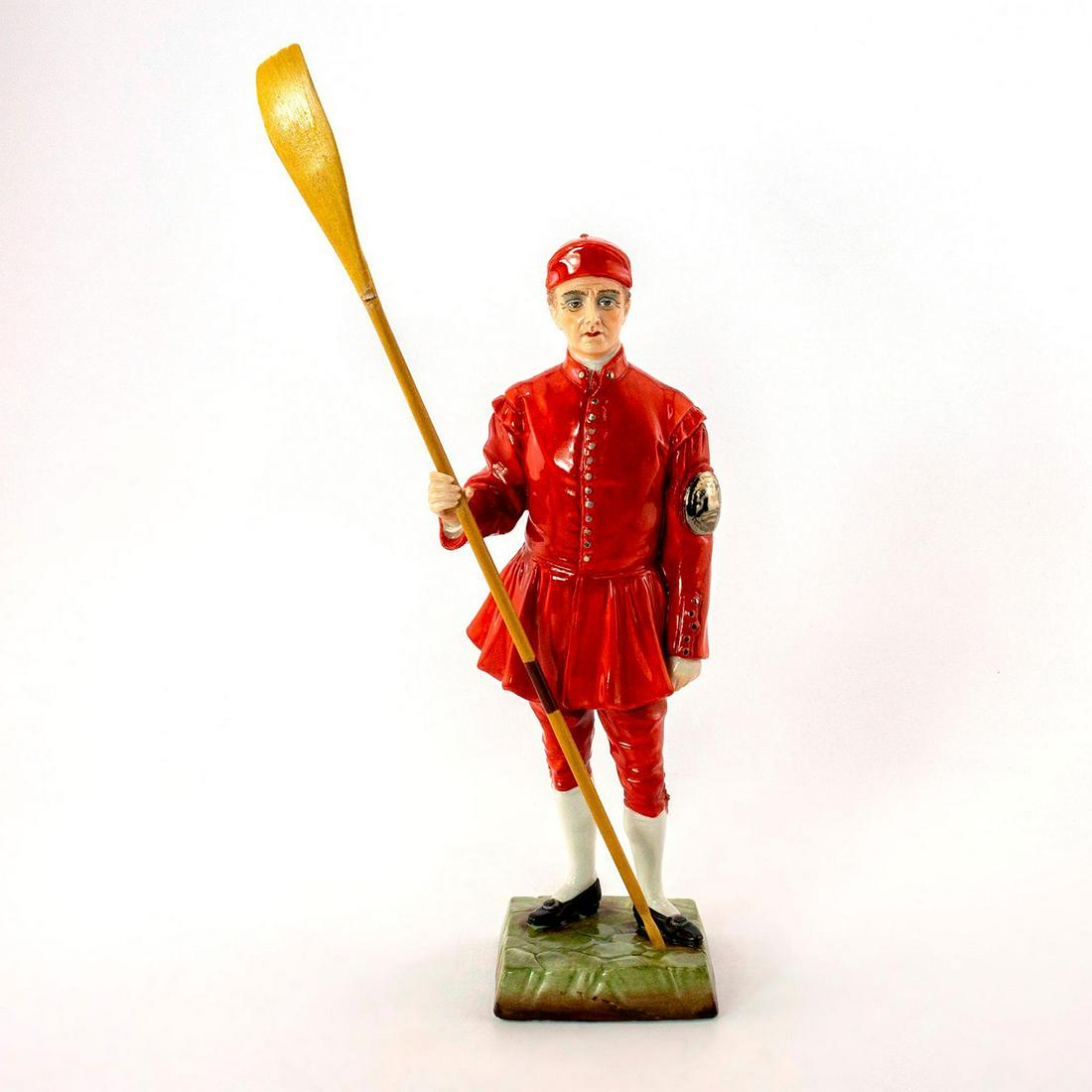 Vintage Sitzendorf Figurine, Waterman Doggett Winner: Glossy porcelain, highly detailed. Hand painted in vibrant red with silver badge and buttons. Carries original wooden oar. Sitzendorf backstamp. Hand painted title to bottom base. Oar shows signs of w