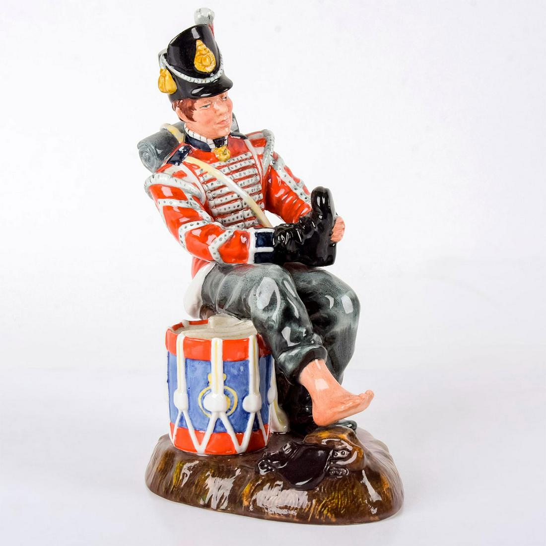 Drummer Boy HN2679 - Royal Doulton Figurine: Glossy finish, highly-detailed figure. Modeled as a drummer putting his boot on. Series: Professions. Royal Doulton backstamp. Artist: Mary Nicoll Issued: 1976 - 1981 Dimensions: 8.5"H Manufacturer: R