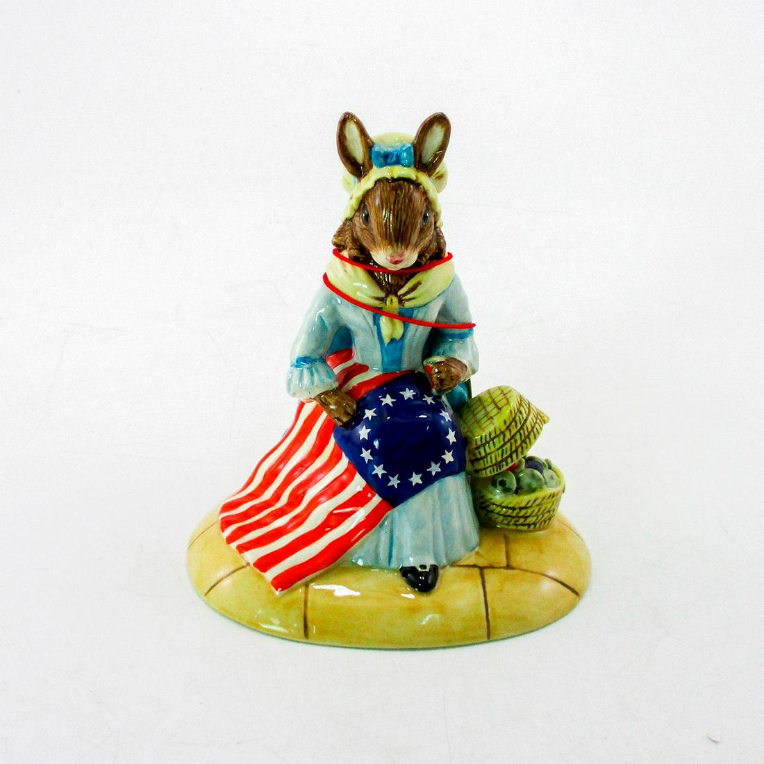 Betsy Ross DB313 - Royal Doulton Bunnykins: Pale blue dress; white collar and cap, red, white and blue flag, brown basket. Bunnykins backstamp. Certificate included. Limited edition number 788 of 2000 pieces. From the American Heritage series. 